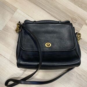 Coach Black Leather Shoulder Bag with Adjustable Strap and Flap Closure